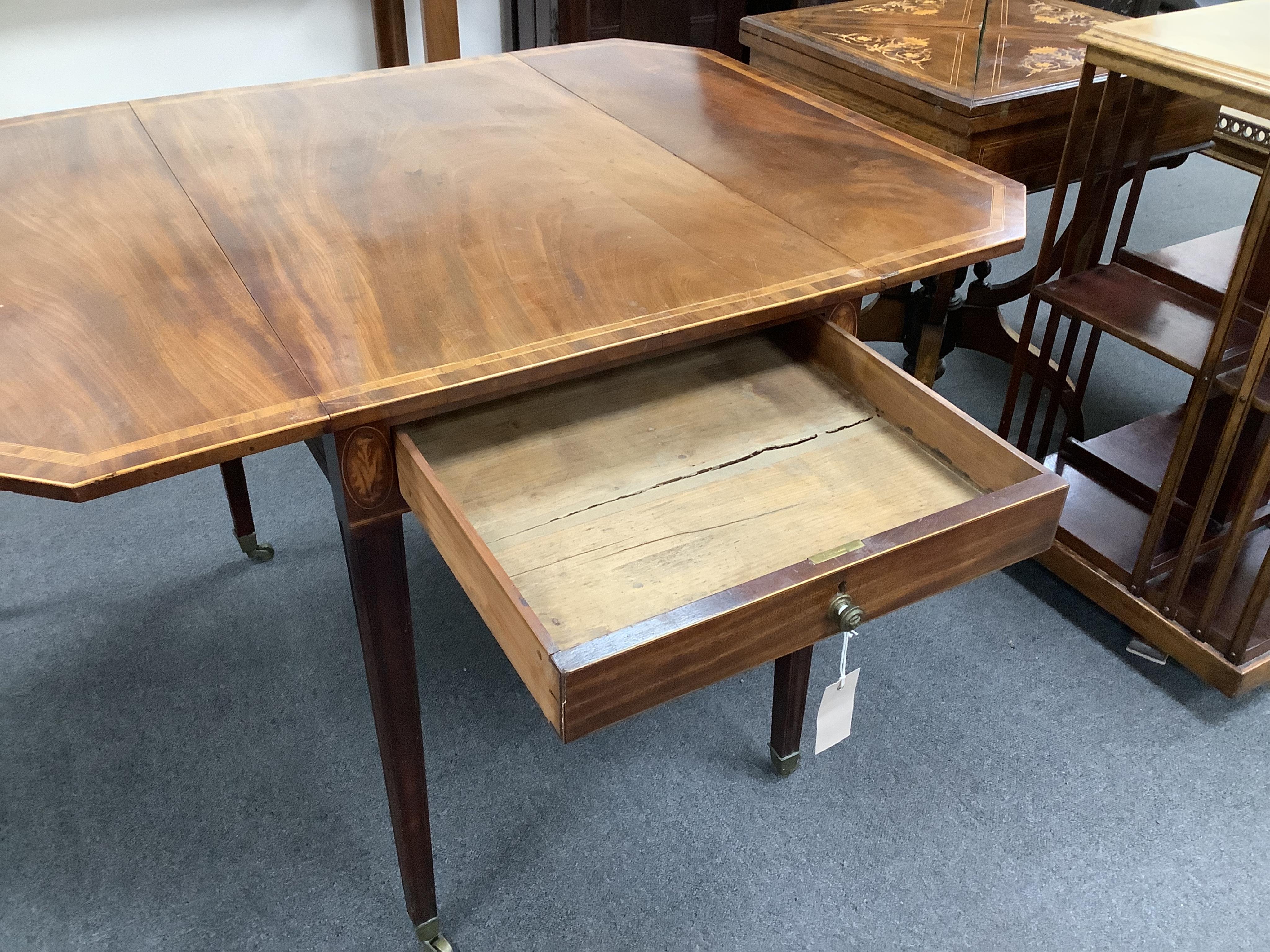 A George III crossbanded mahogany Pembroke table, with canted rectangular flaps and frieze drawer, on moulded squared tapered legs, fitted brass castors, 84cm wide, 54cm deep, 72cm high. Condition - overall of a slightly